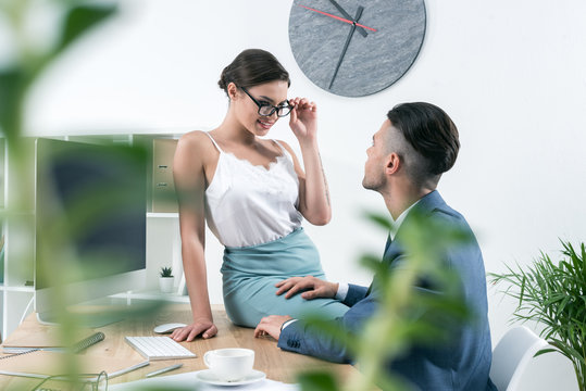 young sexy secretary seducting her boss at workplace in office
