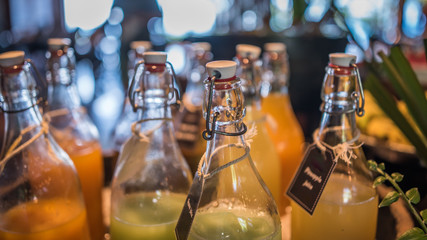 Fototapeta na wymiar Orange Juice In Glass Bottles