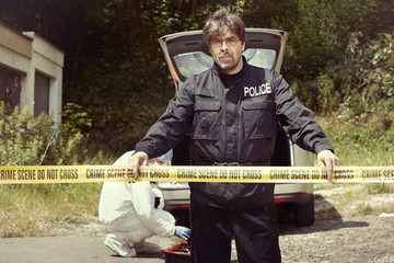 Police team working on abandoned car outdoor