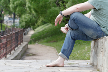 man walking on the road without shoes