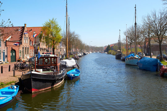 Traditional Dutch Botter Fishing Boats in the small Harbor of the Historic Fishing Village in Netherlands.