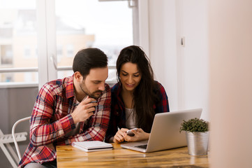 Two young students working on ther project at home