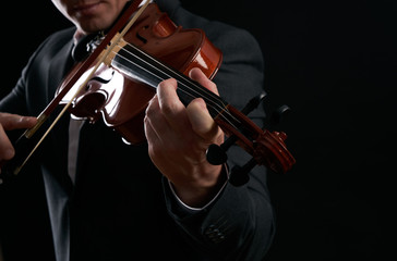Violin player hands. Musician, virtuoso, violinist playing violin against the background of musical...