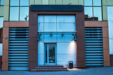 A building of glass at sunset. Entrance to the office