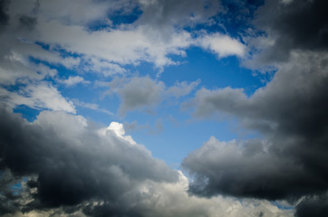 Dramatic sky. Saturated clouds before a thunderstorm, against the background of a blue sky.