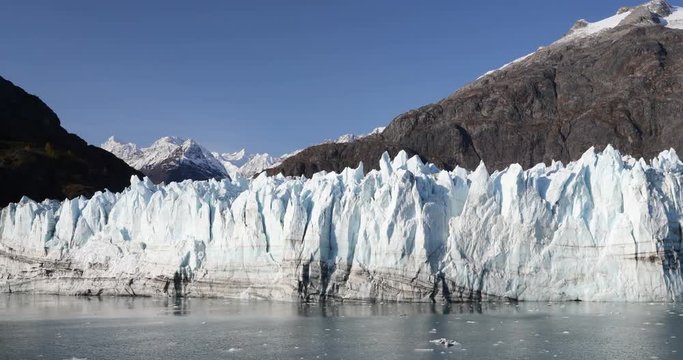 Glacier Bay Alaska cruise vacation travel. Global warming and climate change concept with melting ice. Panning landscape of Margerie Glacier and Mount Fairweather Range mountains.