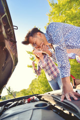 Young couple on the road has problems with their car