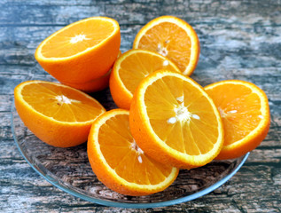Half cut oranges on wooden background