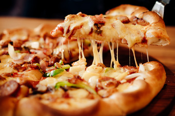 Pizza cheese and soft drink  on wooden table