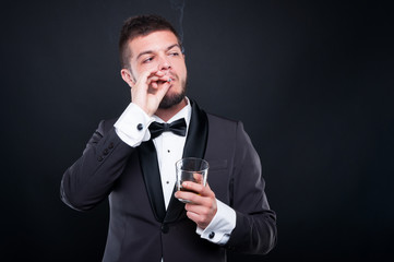 Man smoking cigar and drinking fine cognac