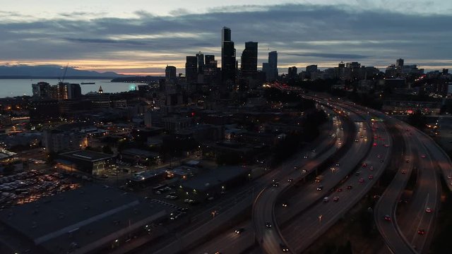 Helicopter Aerial of Freeway Commuter Cars Traveling from City at Night