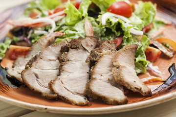 Slices of boiled pork and vegetables on a plate