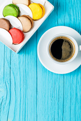 Multicolored macaroons with black coffee