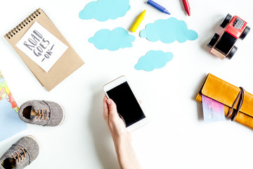 accessories for treveling with children and mobile phone on white background top view mock-up