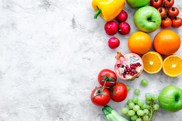 fruits and vegetables for healthy dinner on stone background top view mock up