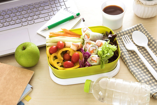 Close up green Lunch box on the work place of working desk ,Healthy eating clean food habits for diet and health care concept