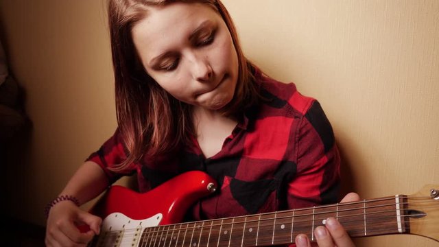 Teen Girl Playing Guitar At Home. Close-Up 4K Slow motion