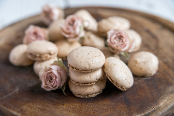 Beige macarons and dry roses vintage background