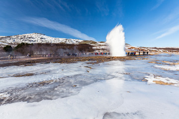 Tourists watching an eruption of the Strokkur Geysir on the Golden Circle, Iceland