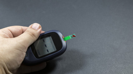 checking blood glucose for treatment studio image