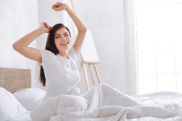 Radiant woman waking up in morning