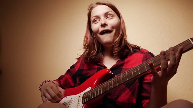 Teen Girl Playing Guitar At Home. Close-Up 4K Slow motion