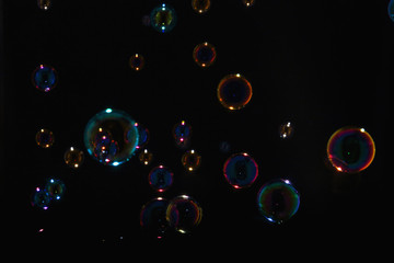 Rainbow soap bubbles on a black background