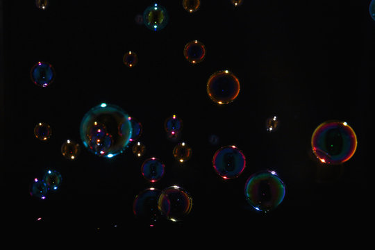 Rainbow soap bubbles on a black background