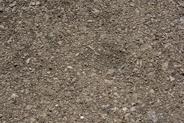 Abstract background of closeup dark uneven asphalt