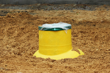 Plastic tank gas oil catcher in the ground during the construction of a car park for tourist buses,...