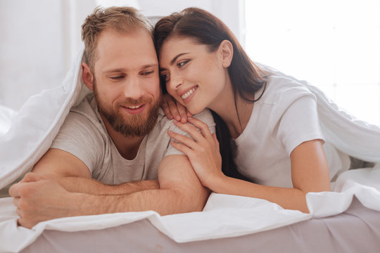 Lovely Couple Having Pillow Talk Underneath Blanket