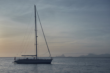 Yacht at Cala Saona in Formentera at sunset. Spain