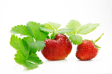 Fresh, ripe, juicy and mouth-watering strawberries with green leaves