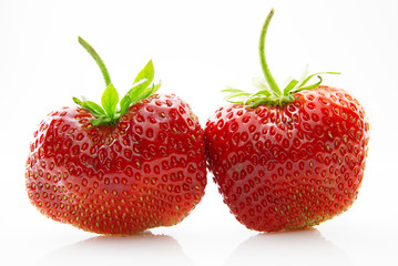 Fresh, ripe, juicy and mouth-watering strawberries with green leaves