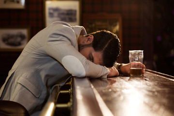 Drunk man sleeping on a pub counter
