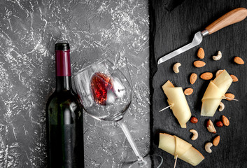 red wine with cheese on dark background top view