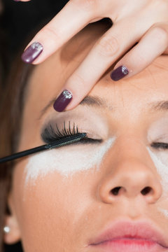 Make-up artist applying mascara
