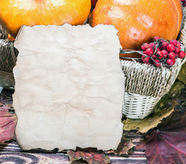 fresh produce pumpkins for Halloween and a sheet of paper for your text. Holiday decorations