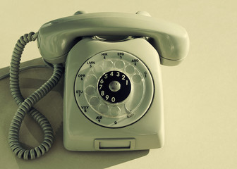 Old stationary phone with the round dial