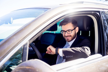 Businessman checking time in car