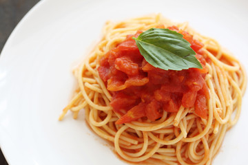 spaghetti with tomato sauce and Basil in dark wooden background