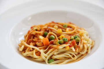 Fettuccine pasta in tomato sauce isolated in white background