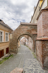 Fototapeta na wymiar Pasajul Scarilor, ancient arch in the historic center of Sibiu, Romania, in a moment of tranquility