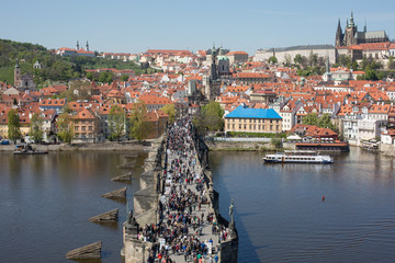 Fototapeta premium PRAGUE, CZECH REPUBLIC - APRIL 16, 2014: Charles bridge one of the landmarks of Prague where tourists visit.