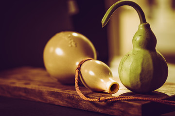 Vintage image and soft light of  fresh calabash  and Stone calabash amulet on wood