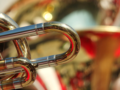 detail of a trombone in an abstract image of a brass section of a band or orchestra