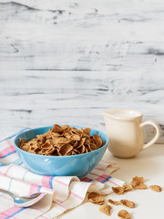 Wheat buckwheat bran breakfast cereal with milk in ceramic bowl