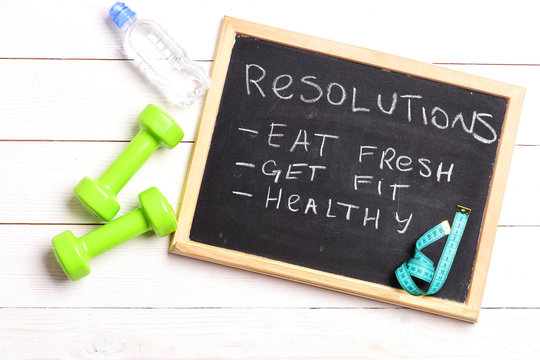 Chalkboard with resolutions: eat fresh, get fit and healthy