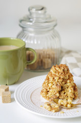 Coffee in a green mug and dessert from a shortbread in the form of a hill