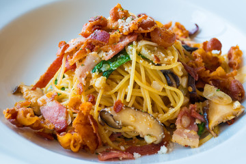 Close up spaghetti with mushroom, bacon, garlic , cheese and dried chilli